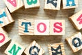 Alphabet block in word TOS abbreviation of Terms of service with another on wood background Royalty Free Stock Photo