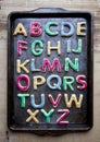 Alphabet in decorated colourful cookies on baking tray Royalty Free Stock Photo