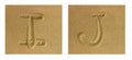 Alphabet I-J on sand Royalty Free Stock Photo