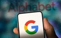 Alphabet Inc. and Google logo displayed on a smartphone