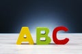 Alphabet letter ABC on wooden desk over and lighting effect