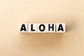 Alphabet letter in word aloha on wood background