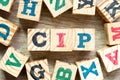 Alphabet block in word CIP Abbreviation of Carriage and Insurance Paid To with another on wood background