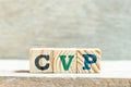 Alphabet block in word CVP Abbreviation of Cost Volume Profit or Central venous pressure on wood background
