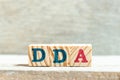 Alphabet block in word DDA Abbreviation of Depreciation, depletion and amortization or demand deposit account on wood Royalty Free Stock Photo