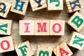 Alphabet block in word IMO Abbreviation of in my opinion with another on wood background