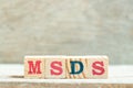 Alphabet block in word MSDS Abbreviation of material safety data sheet on wood background