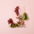 Alphabet. Letter J made of wineglasses with rose and white wine, grapes, leaves and corks lying on pink background. Wine Royalty Free Stock Photo