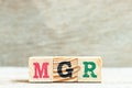 Alphabet in word mgr abbreviation of manager on wood background Royalty Free Stock Photo