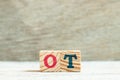 Alphabet in word ot abbreviation for overtime on wood background