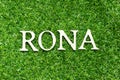 Alphabet in word RONA Abbreviation of Return on net assets on green grass background