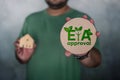 Alphabet letter in word tag EIA, abbreviation of Environmental Impact Assessment on man hand