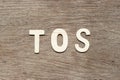 Letter in word TOS abbreviation of Terms of service on wood background