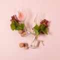 Alphabet. Letter Y made of wineglasses with rose and white wine, grapes, leaves and corks lying on pink background. Wine Royalty Free Stock Photo