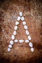 'A' alphabet made form white stone