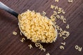 Alphabet pasta in spoon on wooden background Royalty Free Stock Photo