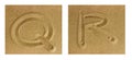 Alphabet Q-R on sand Royalty Free Stock Photo