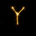 Alphabet sparklers on black background single letter