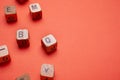 Alphabet wood dices on orange background Royalty Free Stock Photo