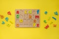 Alphabet wooden board with colored font letters in cells closeup isolated Royalty Free Stock Photo