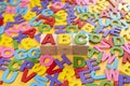 Alphabet on wooden tiles and ABC on a cube against yellow background Royalty Free Stock Photo