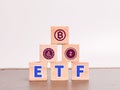 Alphabets ETF on wooden cubes with crypto currency symbol.