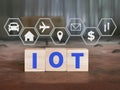 Alphabets IOT stand for Internet Of Things on wooden cubes with icons.