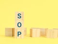 Alphabets SOP standard operating procedure on wooden cubes.