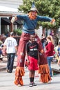 Man Wearing Scarecrow Costume On Stilts Poses For Photo