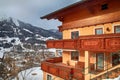 Alpin house with wooden balcony in winter mountain village, Alps