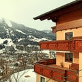 Alpin house with wooden balcony in winter mountain village, Alps Royalty Free Stock Photo