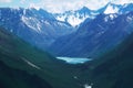 Alpine beautiful blue lake in Altai in a mountain gorge with high mountains with snow-capped peaks in summer Royalty Free Stock Photo