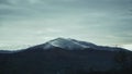 Alpine Bliss: Hillside Village Nestled Beneath Snow-Capped Peaks