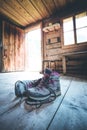 Alpine boots on rustic wood floor in an abandoned mountain chalet in Austria Royalty Free Stock Photo