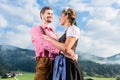 Alpine cattle farmers on mountain meadow Royalty Free Stock Photo