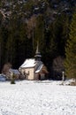 Alpine church near Braies lake along the walkway between the forest