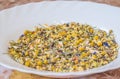 Alpine Field. Herbal tea with lemongrass, flowers and camomile on the white plate. Top view. Close up. High resolution. Alpine Royalty Free Stock Photo