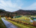 Alpine Isar river and Isarbrucke bridge view from Sylvenstein Stausee damm , Bavaria, Germany. Autumn overcast, foggy and drizzle