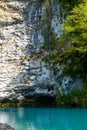 Alpine lake with clear blue water among the rocks in summer in the mountains of Abkhazia Royalty Free Stock Photo