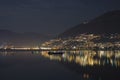 Alpine Lake Maggiore At Night With Cityscape And Reflection In Ticino, Switzerland