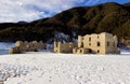 Alpine lake with ruins of old houses partially submerged by water