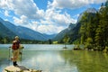 Alpine lake in summer, hiker woman