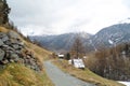 Alpine landscape with dirt road along the mountain slope Royalty Free Stock Photo