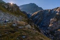 Alpine landscape near the Scaletta hut, in Blenio, Ticino, Switzerland. The sun has just risen and peeps out of a
