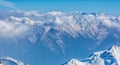 Alpine landscape with peaks covered by snow and clouds Royalty Free Stock Photo