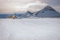 Alpine landscape with peaks covered by snow and clouds, beautiful colors at the top of a glacier. Royalty Free Stock Photo