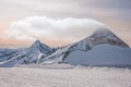 Alpine landscape with peaks covered by snow and clouds, beautiful colors at the top of a glacier. Royalty Free Stock Photo