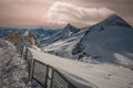 Alpine landscape with peaks covered by snow and clouds, beautiful colors at the top of a glacier. Royalty Free Stock Photo