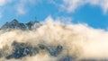 Alpine landscape with peaks covered by snow and clouds Royalty Free Stock Photo