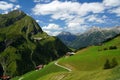 Alpine landscape with scattered houses on a hillside